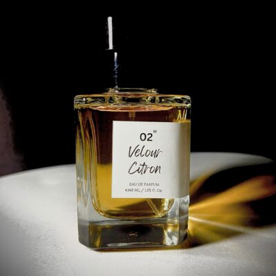 Glass perfume bottle of Bois et Fleurs Parfums featuring notes of pink pepper, lime, lavender, frankincense, vanilla, whipped cream, and dark chocolate.