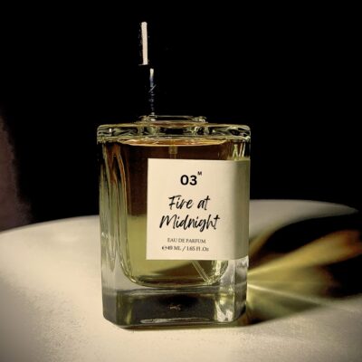 Perfume bottle of Fire at Midnight by Bois et Fleurs Parfums, featuring notes of mandarin, cinnamon, frankincense, cedarwood, tobacco, and leather.