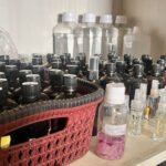 A collection of early fragrance samples, raw aroma chemicals, and a rose tincture made by hand — representing the experimental roots of Bois et Fleurs Parfums and the perfumer’s journey from raw material to finished scent.