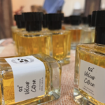 A bottle of Velour Citron glowing in its natural hue — no added colorants, just pure perfume.